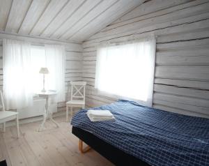 a bedroom with a bed and a table and a window at Mannflogården Bed & Breakfast , Sälenfjällen in Sälen