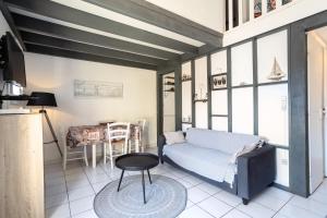 a living room with a couch and a table at Maison Barcares fb 114 in Le Barcarès