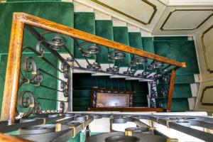 a room with a green wall with chairs and a mirror at Hotel Ca' Dogaressa in Venice