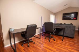 a room with a desk and two chairs and a couch at EV-Friendly- 15 Mins to Downtown in Birmingham