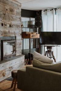 a living room with a couch and a fireplace at Le Bois Saint Martin in Saint-Martin-de-Ré