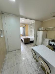 a room with a room with a bed and a refrigerator at Apartamento Centro Manaus 921 in Manaus