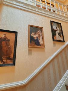 a group of paintings hanging on a wall at The Robin Hill in Torquay