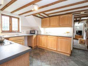 a kitchen with wooden cabinets and a counter top at Bluebell in Woodbridge