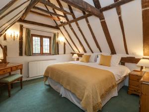 a bedroom with a large bed and a desk at Bluebell in Woodbridge