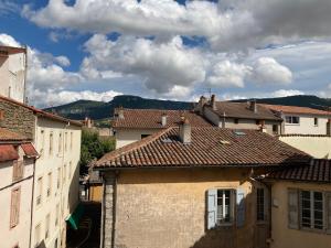 a view of a city with buildings and mountains at Duplex de la République in Millau