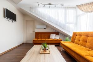 a living room with a couch and a table at Vila Sonata Palanga in Palanga
