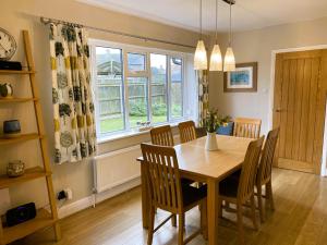 a dining room with a wooden table and chairs at 3 Bed in Wighton KT085 in Wighton