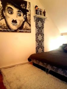 a bedroom with a poster of a woman with a hat at Achilles house in Budapest
