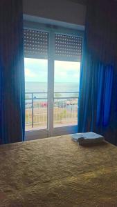 a bedroom with a bed and a view of the ocean at B&B Solana in Noli