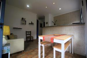 a kitchen with a table and chairs in a room at Casazul - OP in Ouro Preto