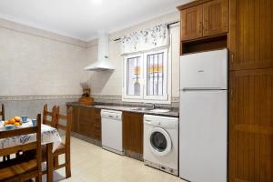 Una cocina con un frigorífico blanco y un lavavajillas. en Aptº Jábega, Familias y Parejas, en Conil de la Frontera