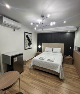 a bedroom with a large bed and a table at Wyka Hotel in Trujillo