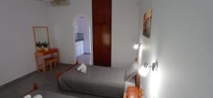 a bedroom with a bed and a table and a mirror at Hermes in Kavos