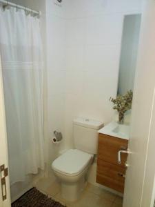 La salle de bains blanche est pourvue de toilettes et d'un lavabo. dans l'établissement Dept. en centro de Los andes/Apartment Los Andes, à Los Andes
