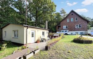 a small house with a garden and a building at Lovely Home In Klpinsee-usedom With Kitchen in Kolpinsee