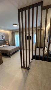 a large bedroom with a bed and a large sqor at Sunset Hotel in Ouranoupoli