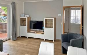 a living room with a tv and a chair at Lovely Home In Klink With Kitchen in Klink