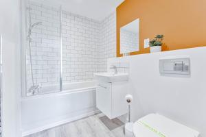 a white bathroom with a tub and a sink at Contemporary 2 Bed Apartment Nightingale Quarter Derby in Derby