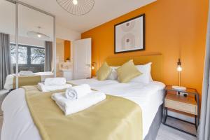a hotel room with two beds with towels on them at Contemporary 2 Bed Apartment Nightingale Quarter Derby in Derby