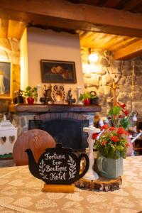 a table with a sign that reads enchanted beehiverequired beehiverequired at Fortuna Eco - Boutique Hotel in Băile Tuşnad