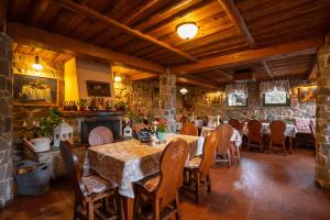 a dining room with tables and chairs and a stone wall at Fortuna Eco - Boutique Hotel in Băile Tuşnad +67 photos