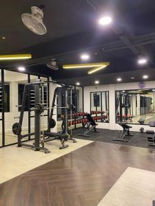 a gym with several treadmills and machines in a room at The Cove in Ipoh
