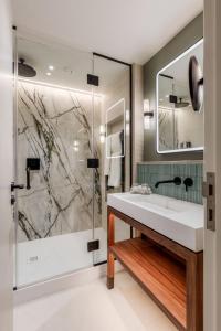 a bathroom with a sink and a shower at Sopwell House Hotel in St. Albans