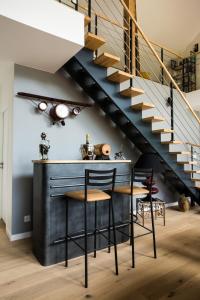 una cocina con barra bajo una escalera en Magnificent villa with heated swimming pool and air conditioning! en Viviers-du-Lac