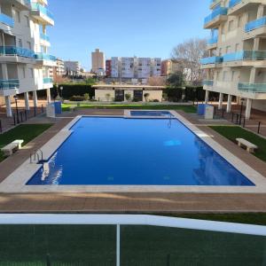 une piscine vide en face d'un bâtiment dans l'établissement Apartamento nuevo en playa de Piles. Costa Blanca, à Piles