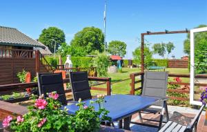 a blue table and chairs in a garden at Ferienhaus Lassan Bei Wolgast in Lassan