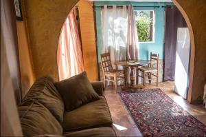 a living room with a couch and a table at Hacienda Hideaway + Mountain View, Creek & Trails in Topanga