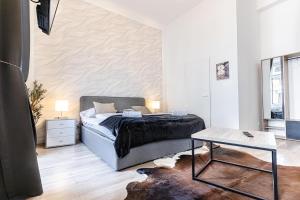 a bedroom with a bed and a table at Mariahilfer Boutique Rooms - Virtual Reception & Self-Checkin in Vienna