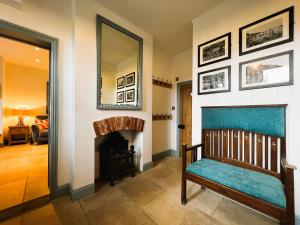 a living room with a chair and a fireplace at Belverdere Cottage - Pet friendly in Ventnor