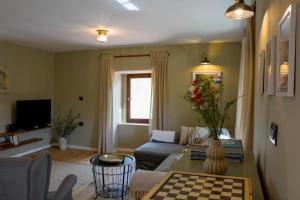 a living room with a couch and a table at Cosy Getaway in Gostinjac