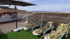 a group of chairs sitting on top of a roof at Casa Rural Los Pequeños (Monserrat) in Monserrat