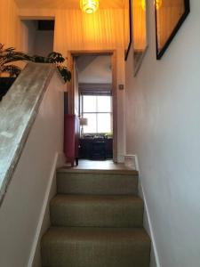 a staircase in a house with a stair case at 2 Bed Apt with air con - 10min to Canonbury Station in London