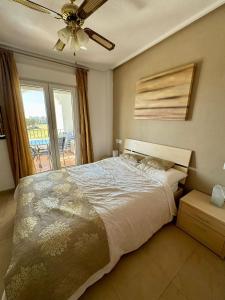 a bedroom with a bed and a ceiling fan at Casa Gavendy, La Torre Golf Resort in Murcia
