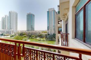 a balcony with a view of a river and buildings at Turia Block A - Vacationer in Dubai