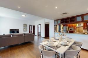 a dining room and living room with a table and chairs at Turia Block A - Vacationer in Dubai