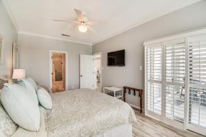 a bedroom with a bed and a ceiling fan at Dolphin Harbor Orange Beach Condo w/ Beach Access! in Orange Beach +18 photos