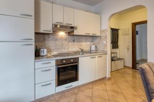 a kitchen with white cabinets and a sink at Apartment Mirjana in Karigador in Karigador