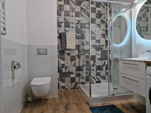 a bathroom with a shower and a toilet and a sink at Apartament Levante in Władysławowo +18 photos