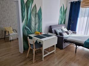a room with a bed and a table and a couch at Apartament Levante in Władysławowo