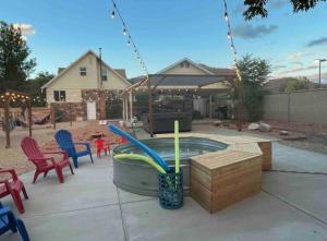 un patio con una piscina con sillas y una mesa en Climber's Paradise, Venture Base Unit 6, en Kanab
