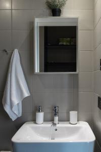 a bathroom with a white sink and a mirror at Zarautz SALBIDE APARTMENTS in Zarautz +17 photos