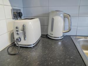 a kitchen counter with a toaster and a toaster at Comfortable stylish room Pass the Keys in Beeston