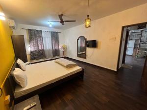 a large room with a bed and a mirror at Jacuzzi house with private terrace ambiance in Pune