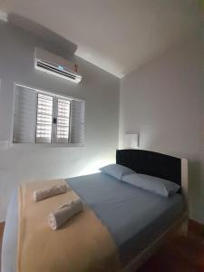 a bedroom with a bed with two pillows on it at Espaço céu Azul in Ribeirão Preto