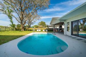 a swimming pool in front of a house at Taj Duval, Sleeps 14, Pool, Lux in Jacksonville Beach
